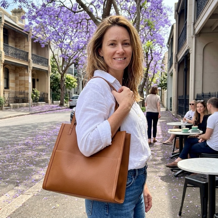 Woman carrying a tan tote bag on a street in Paddington